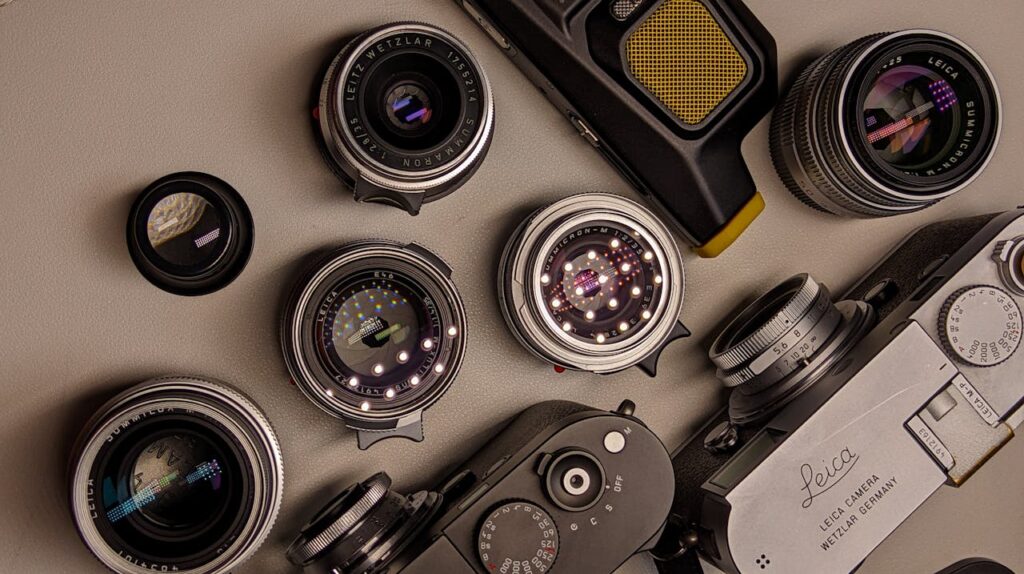 A group of cameras and lenses on a table